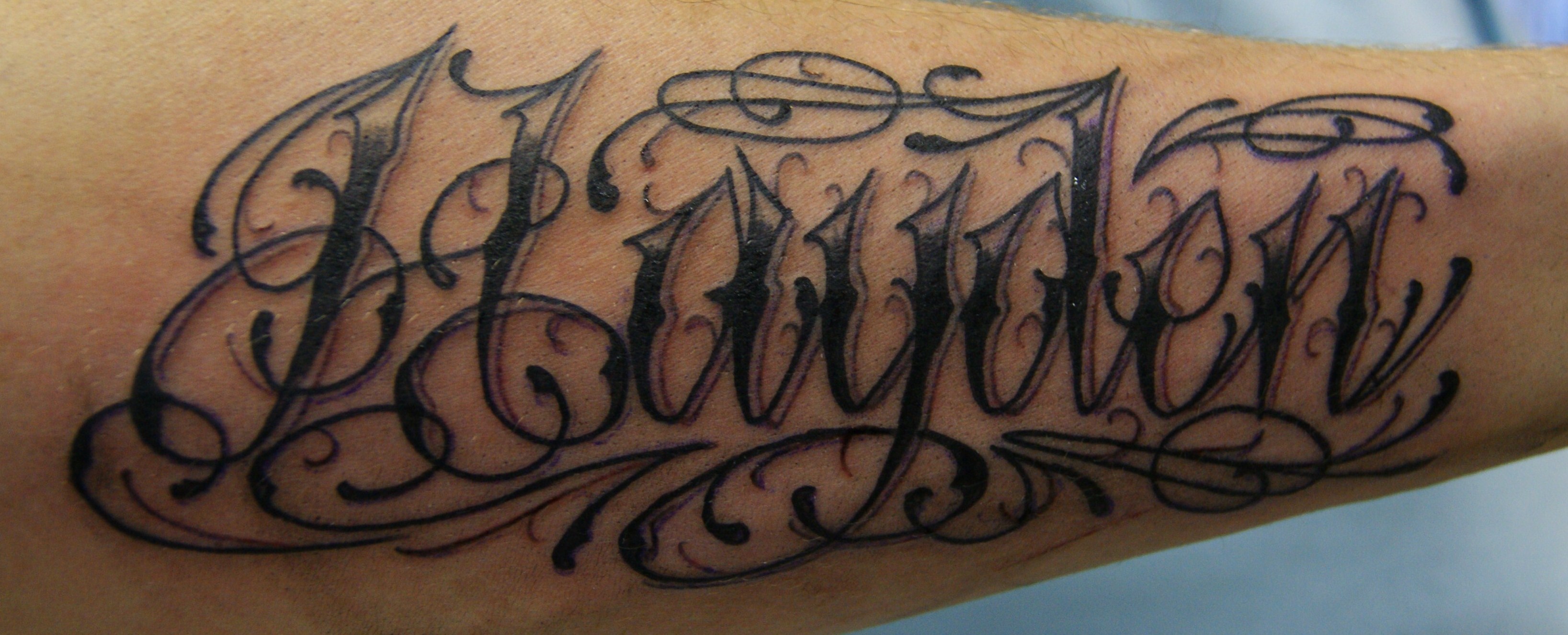 forearm script tattoo